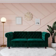 a living room with pink walls and a green couch in front of a white rug