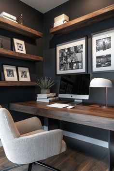 a desk with a chair, lamp and pictures on the wall