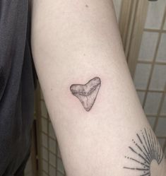 a person with a small tattoo on their arm