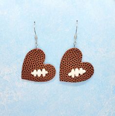 This fun set of earrings shows your love for football and your favorite player!The heart is hand cut from a real leather football. The heart measures 1.5 inches long x 1.75 inches wide. Total drop length is 2 inches.Add your favorite player's number, name, or initial to the hand stamped metal tag for $4 more.Earring hooks are stainless steel, which is hypoallergenic and tarnish resistant.Also available in soccer. Soccer Earrings, Football Heart, Football Bracelet, Baseball Earrings, Football Earrings, Hand Stamped Metal, Get Toned, Stamped Metal, Metal Tag