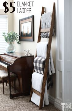 a ladder leaning up against a wall with towels on it and a piano in the corner