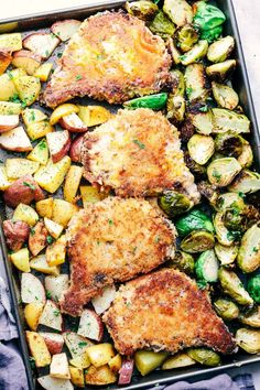 some meat and vegetables are on a sheet pan