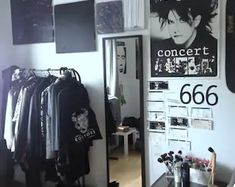 a room with clothes and posters on the wall