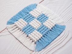 the blue and white rug is laying on top of the wooden floor with fringes