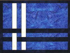 a blue and white quilted piece with two horizontal strips in the center, on a black background