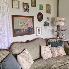 a living room filled with furniture and pictures on the wall