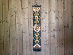 a wooden wall with wood paneling and a decorative design on it