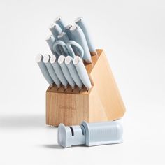 an assortment of kitchen utensils in a wooden holder