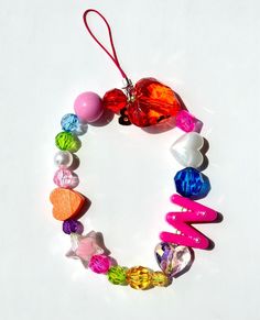 a heart shaped bead necklace with many different colors and shapes on it's side