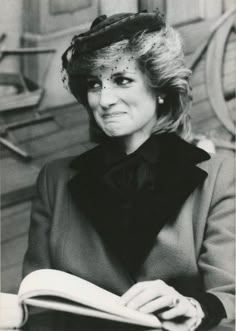 an old photo of a woman reading a book