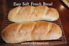 two loaves of bread sitting on top of a cooling rack with the words easy soft french bread