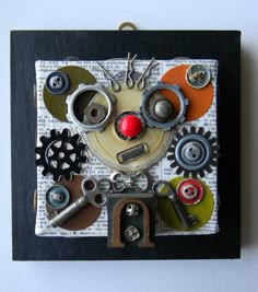 there are many different types of buttons and gears on this piece of art that looks like a clown face