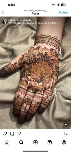 someone is getting their hand painted with henna designs on it, and the photo has been