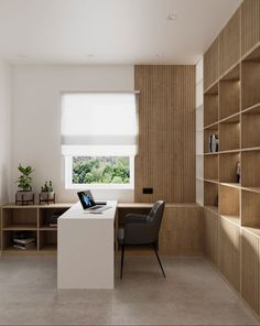 a room with a desk, chair and bookcases on the walls is shown