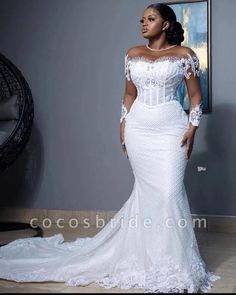 a woman in a white wedding dress posing for the camera