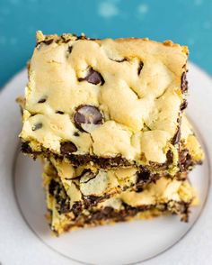 two chocolate chip cookie bars stacked on top of each other in front of a blue background