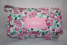 a pink and green flowered bag with a name tag on the front that says palmer