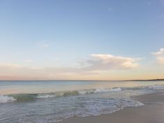 the ocean waves are rolling in to shore