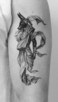 a black and white photo of a man's arm with a tattoo on it