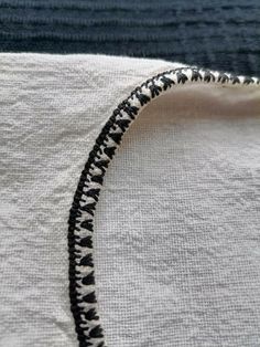 the edge of a piece of fabric with black and white stitching