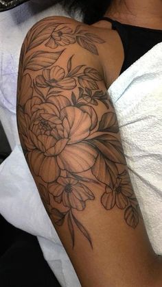 a woman with a flower tattoo on her arm