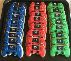 a tray filled with lots of different colored cookies next to numbers on top of each cookie