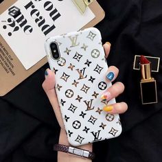 a woman's hand holding an iphone case with louis vuitton on it