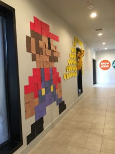 an office hallway decorated with legos and paper mario bros characters on the wall next to each other