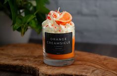 an orange creamsice sits in a glass jar