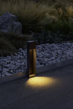 a light shines on the ground next to some rocks