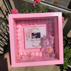 a pink frame with flowers in it