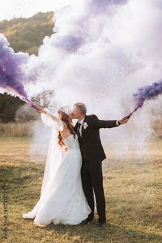 Stock Image: bride and groom playing with colored smoke in purple hands, hugs and kisses. Smoke bombs at a wedding. Wedding Photo Dip Kiss, Crazy Wedding Photos, Bride Shots, Street Wedding, Wedding Extras, Crazy Wedding, Make Lemonade, Bride Photoshoot, Water Wedding