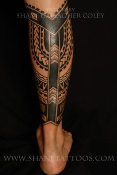 a man's leg with an intricate tattoo design on his arm and foot, in black