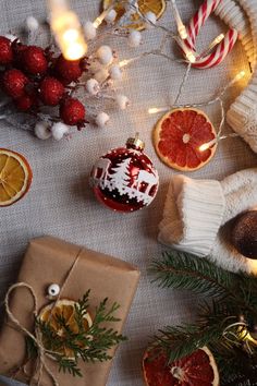 a table topped with oranges and christmas decorations