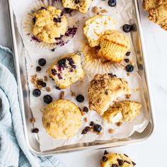 muffins and blueberries on a baking sheet