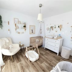 a baby's room is decorated in white and wood with lots of natural greenery