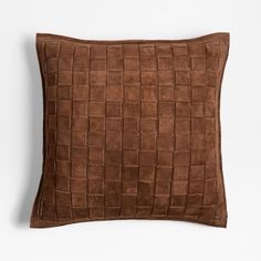 a brown pillow on a white background