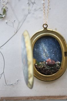 a necklace with an image of a man and woman under a starry sky