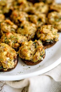 an assortment of stuffed mushrooms on a white plate