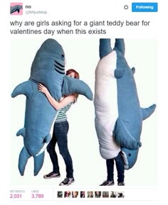 two people standing next to each other in shark costumes