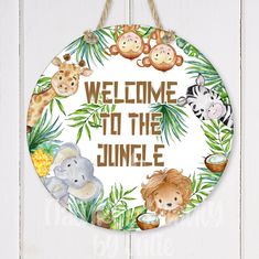 a welcome sign hanging on the side of a white wall with jungle animals and palm leaves