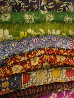 a pile of different colored and patterned fabrics