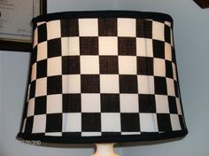 a black and white checkered lamp shade on a table