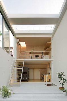 an empty room with stairs leading up to the second floor and bookshelves on either side