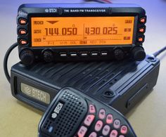 an old radio sitting on top of a table next to a remote control