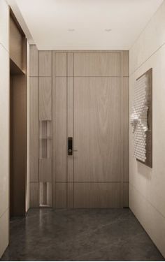 an empty hallway with wooden doors and grey flooring