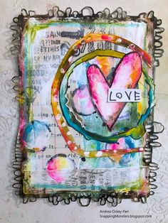 an art journal with the word love written on it and a heart in the middle