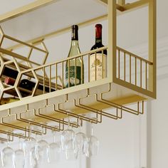 several wine bottles and glasses on a rack