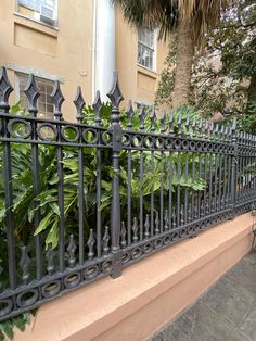 a black iron fence next to a house