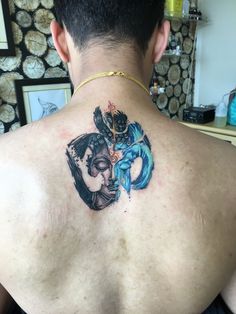 a man with a tattoo on his back